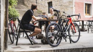Road cyclists sitting at a cafe