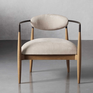A wooden chair with cream upholstery