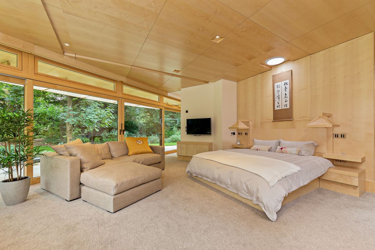 One of the bedrooms inside the zigzag property with large window and view of the garden