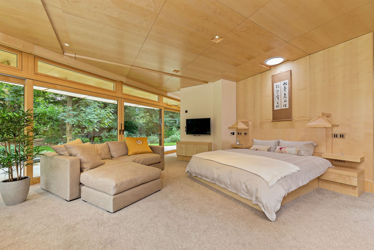 One of the bedrooms inside the zigzag property with large window and view of the garden
