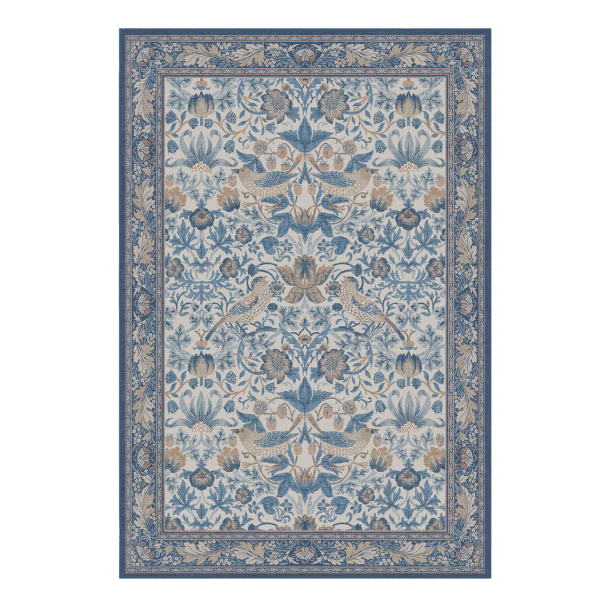 The Ruggable Strawberry Thief Indigo &amp;amp; Ivory rug is blue and cream, with bird and leaf motifs centrally, and a leafy border in darker shades