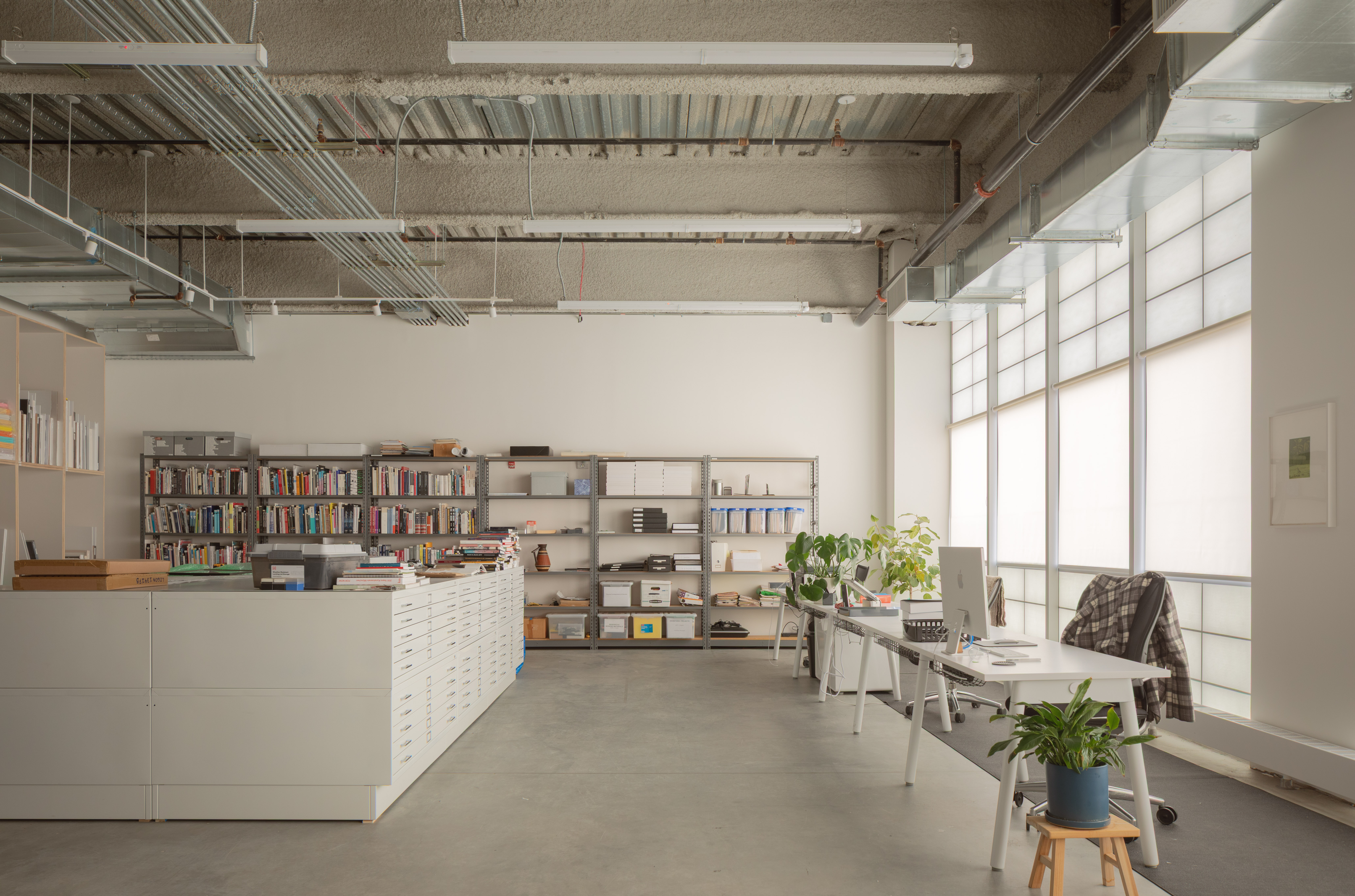 minimalist interior of artist Glenn Ligon's studio by Ravi Raj, with artworks and bespoke utilitarian furniture