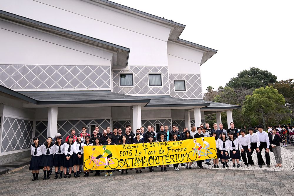 Riders pose outside the Japanese school