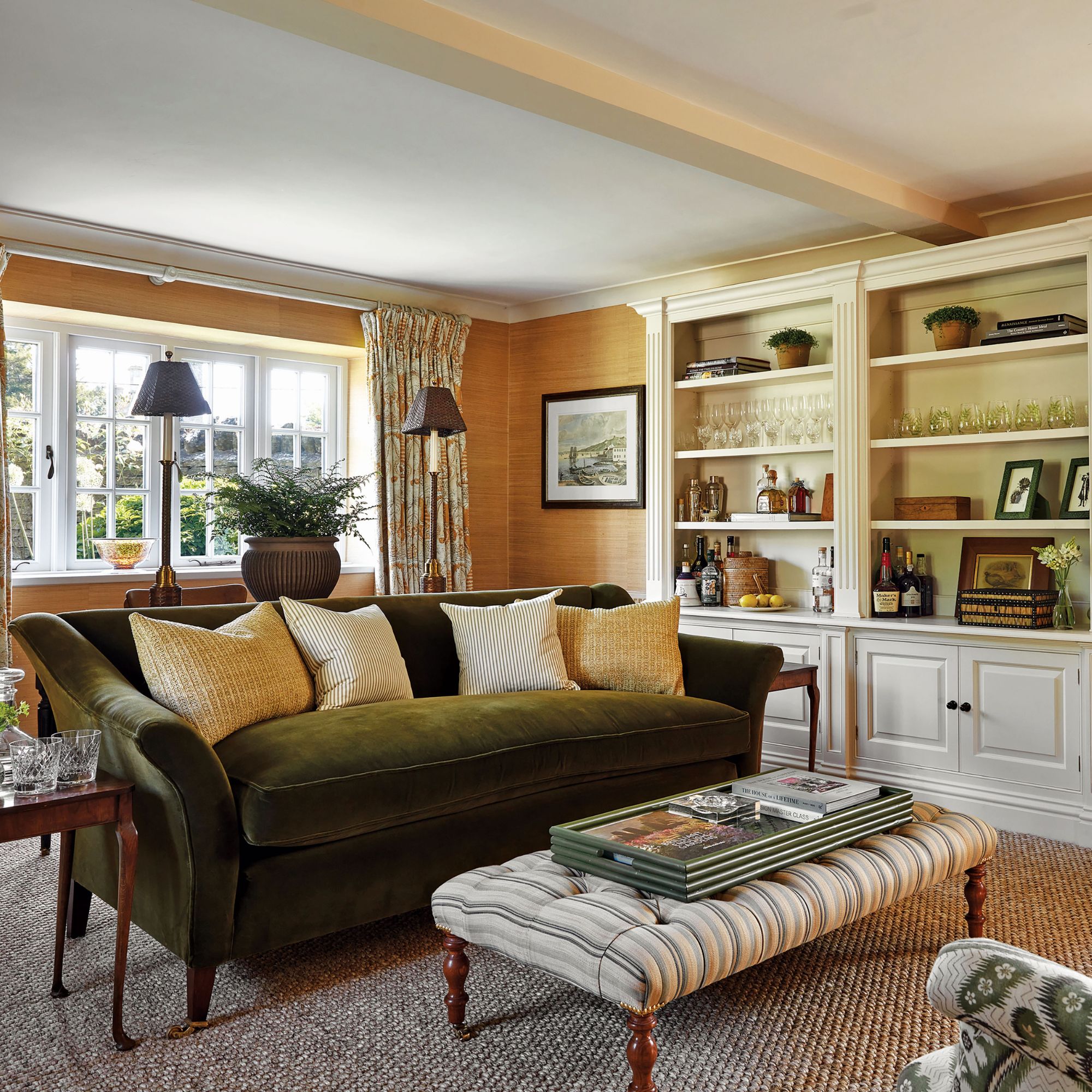Living room with green velvet sofa, wooden accents and large cabinet