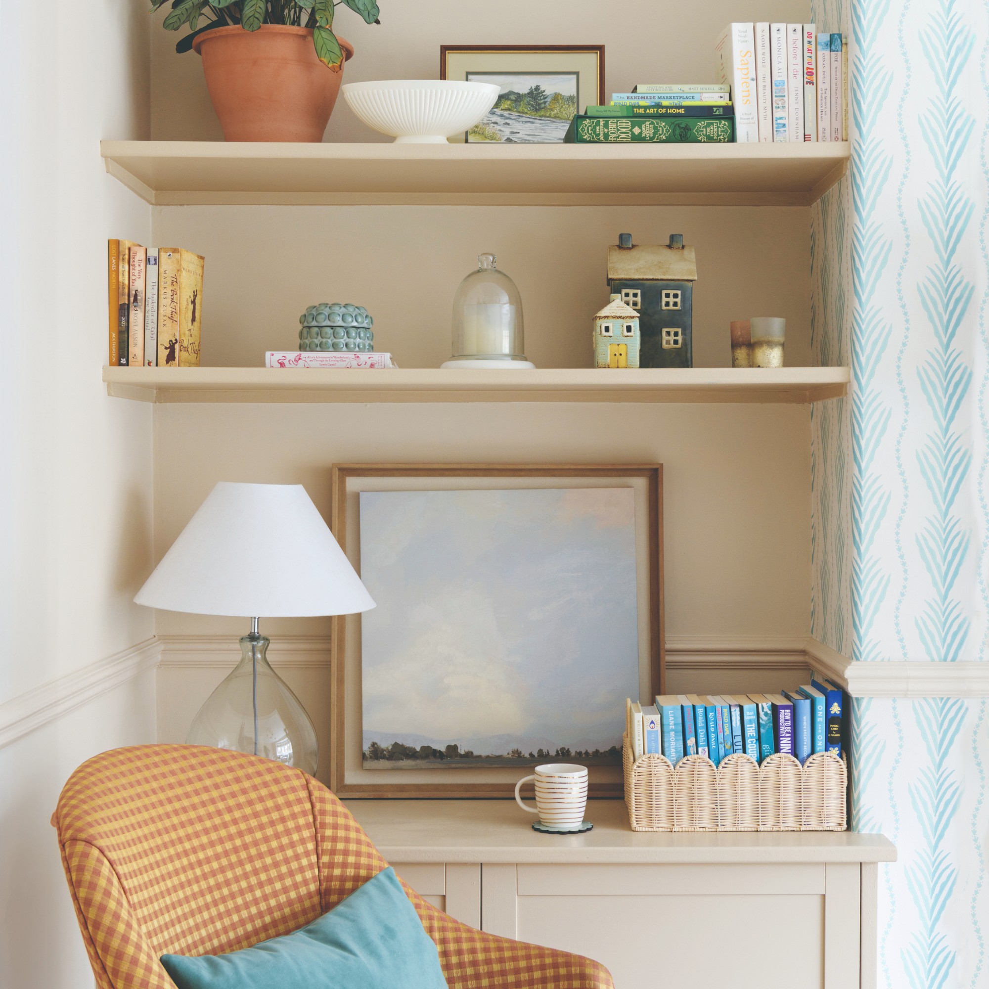 A living room alcove with built-in shelves and a cabinet displaying curated decorative items