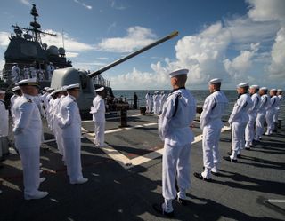Members of the Navy prepare for the start of the burial at sea service for Neil Armstrong aboard the USS Philippine Sea (CG 58), Friday, Sept. 12, 2012, in the Atlantic Ocean.