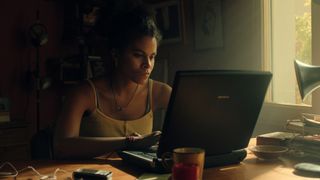 Zazie Beetz's character sits in front of a laptop in Black Mirror season 6
