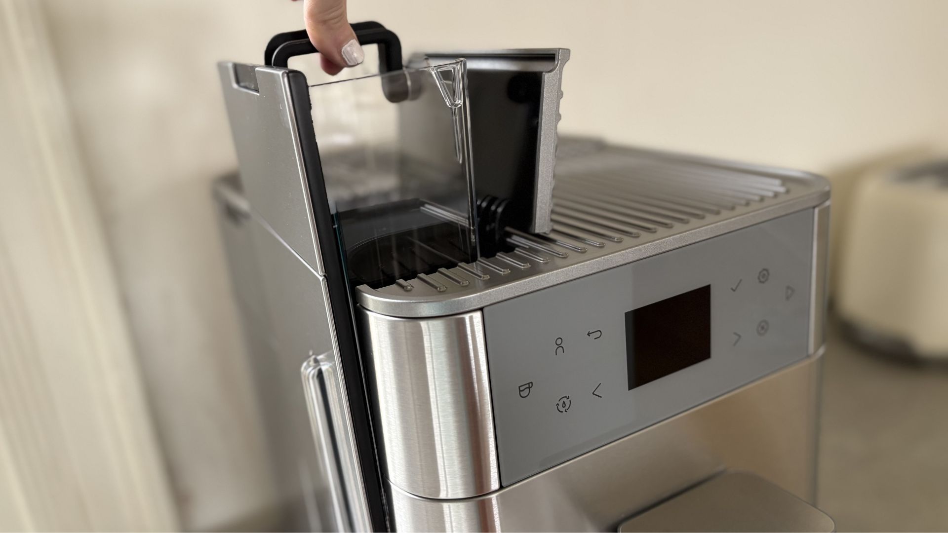Testing the KitchenAid KF6 Fully Automatic Espresso Machine by lifting out the water reservoir