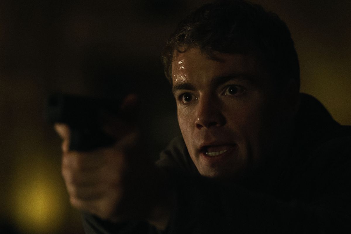 Peter holds up a gun in The Night Agent season 2