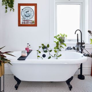 Black and white bathroom with freestanding bath with black claw feet