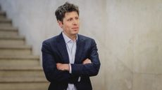 Sam Altman stands with his arms crossed
