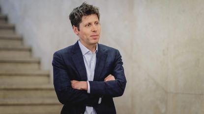 Sam Altman stands with his arms crossed