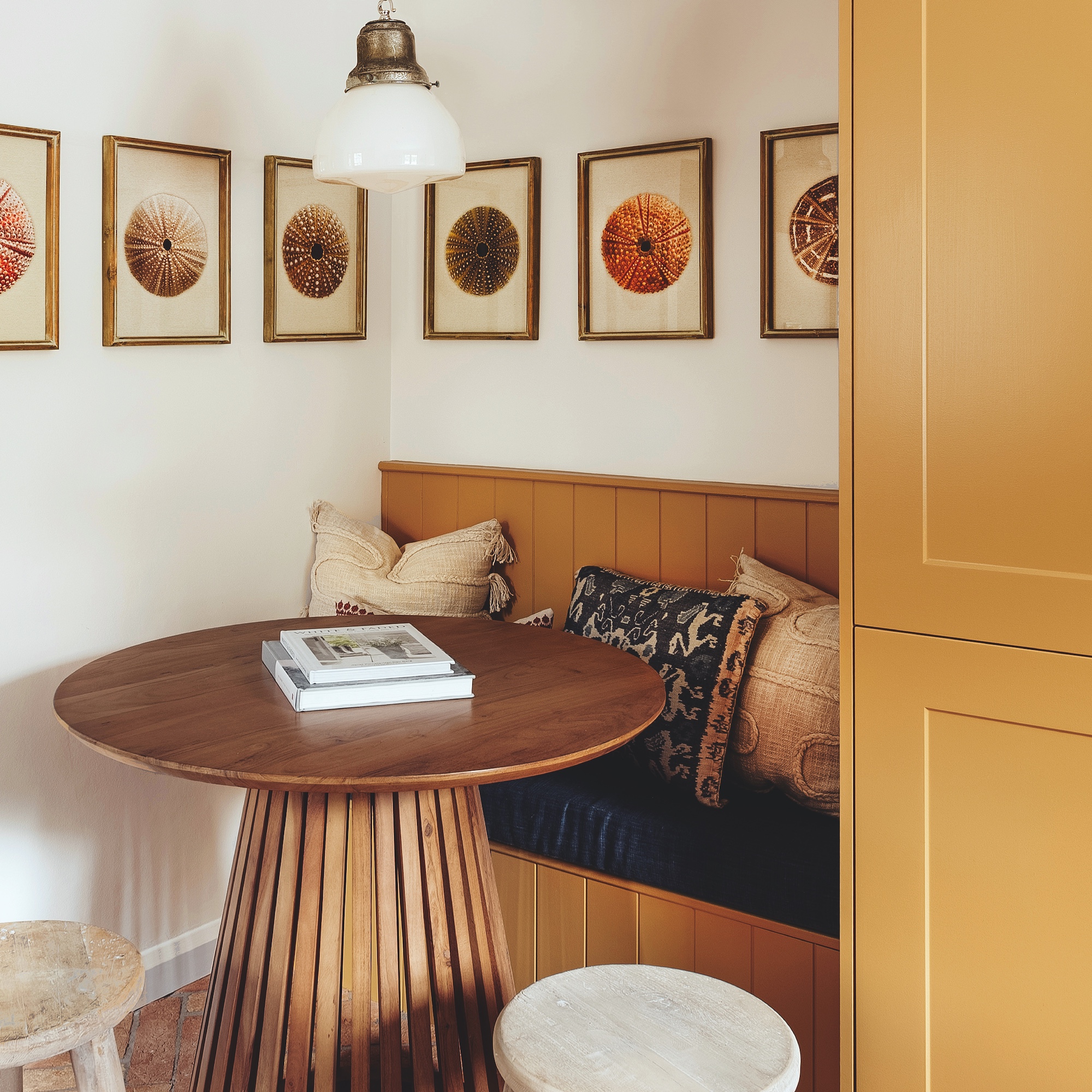 small dining area in kitchen with built-in bench seat and circular wooden table