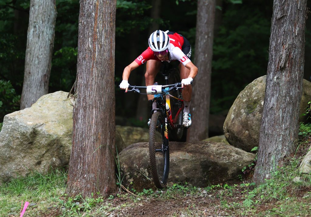 IZU JAPAN JULY 27 Jolanda Neff of Team Switzerland jumps off a boulder during the Womens Crosscountry race on day four of the Tokyo 2020 Olympic Games at Izu Mountain Bike Course on July 27 2021 in Izu Shizuoka Japan Photo by Michael SteeleGetty Images