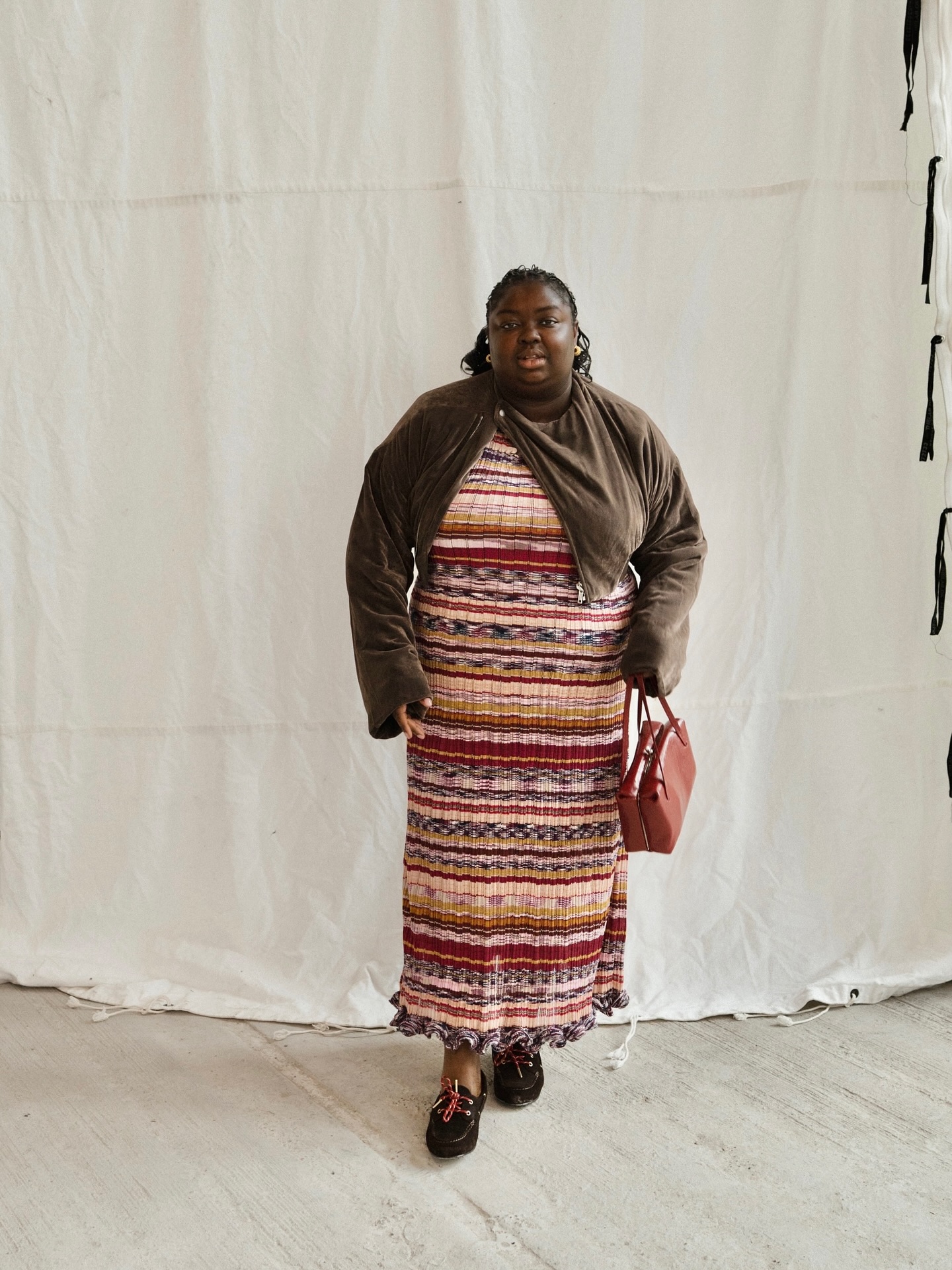 An image of @abimarvel wearing a stripe maxi dress with boat shoes, one of the best lace-up flats.