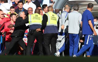 LONDON, ENGLAND - OCTOBER 20: Stewards hold back Jose Mourinho, Manager of Manchester United Chelsea assistant Marco Ianni makes his way towards the tunnel during the Premier League match between Chelsea FC and Manchester United at Stamford Bridge on October 20, 2018 in London, United Kingdom. (Photo by Catherine Ivill/Getty Images)