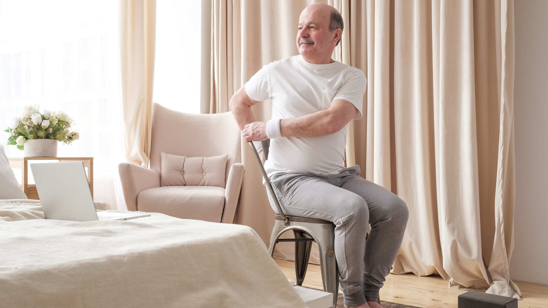 Man sitting in chair twisting to the side