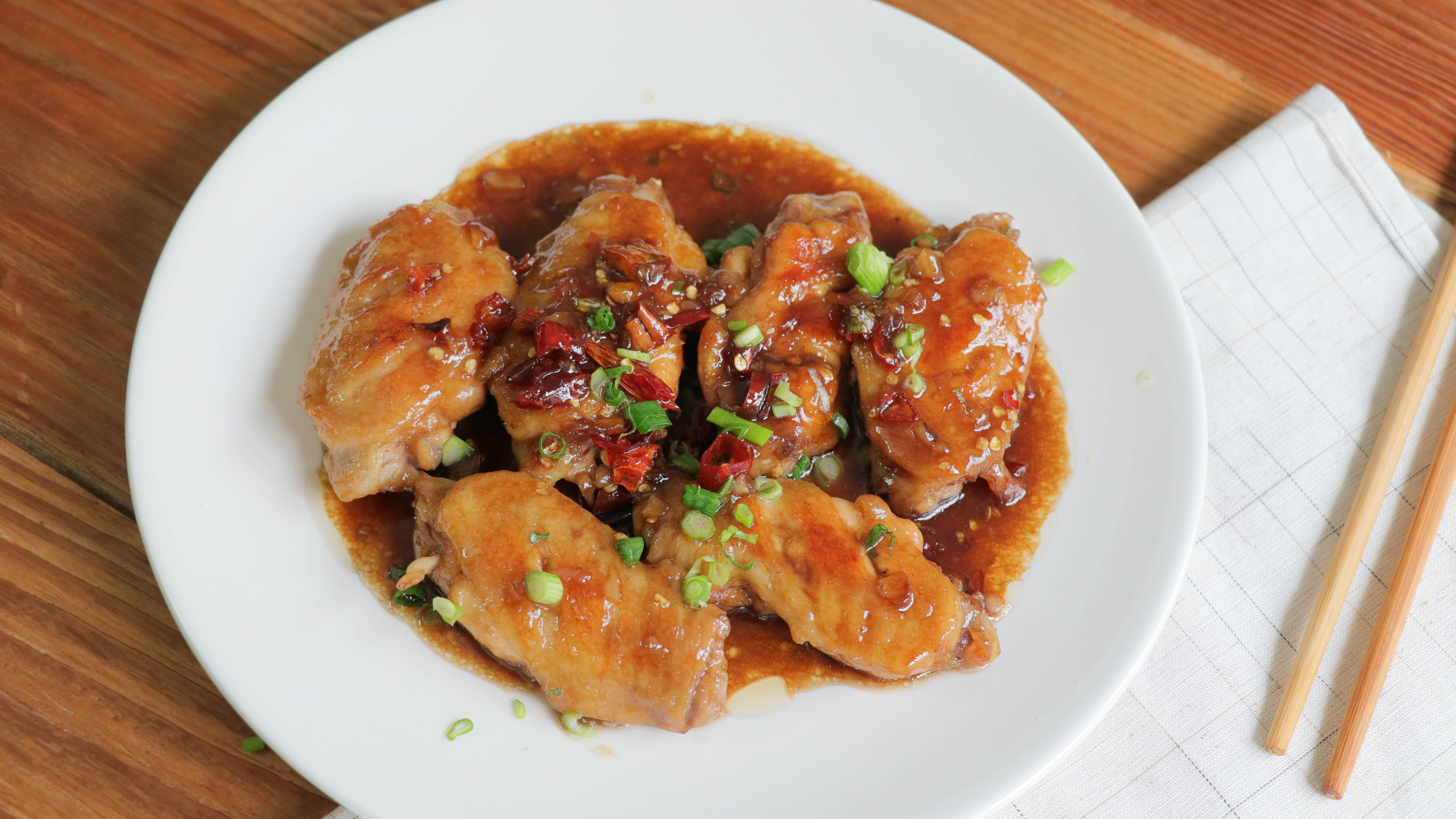 Coca-Cola chicken wings next to chopsticks