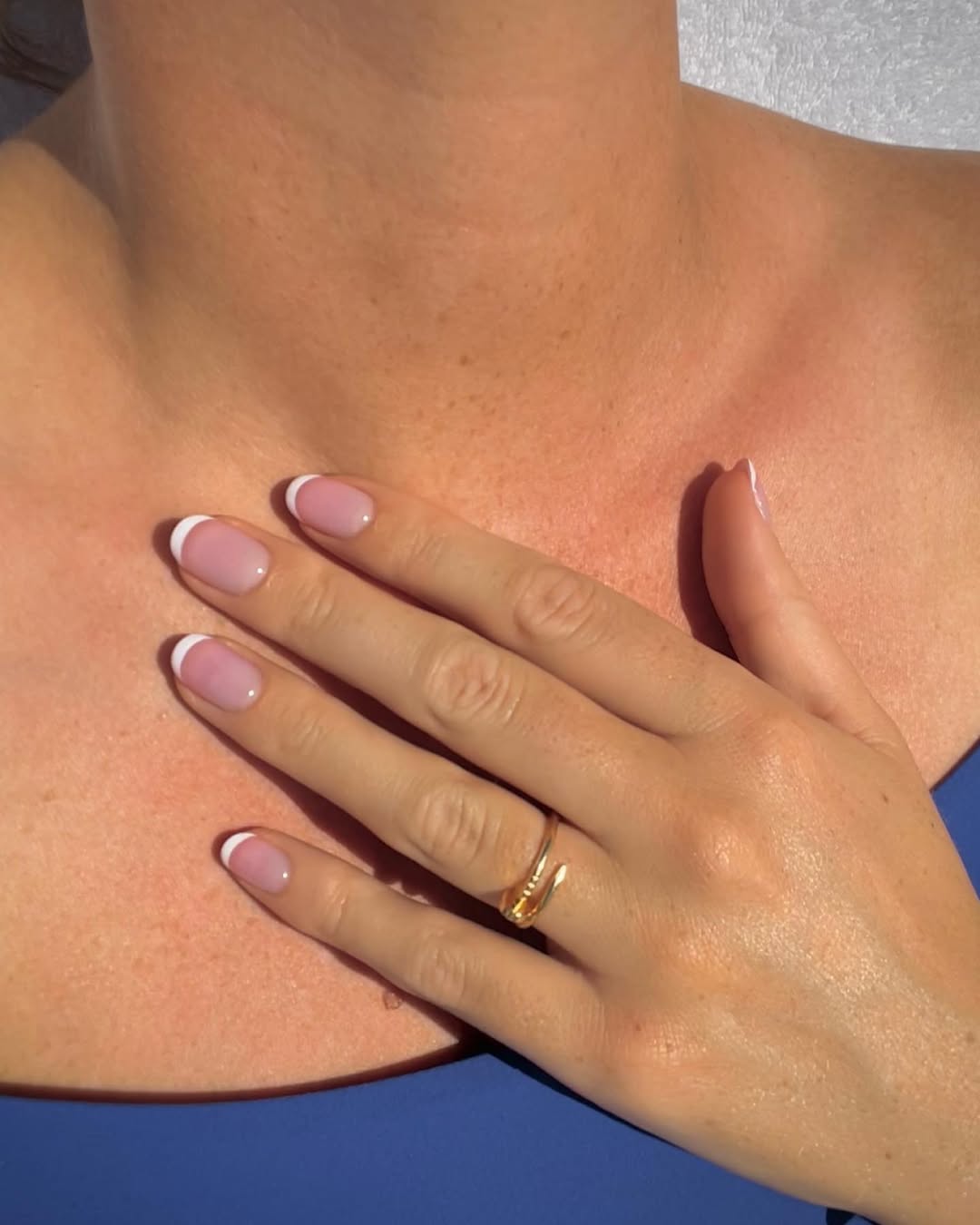 Pink base on short French tip nails