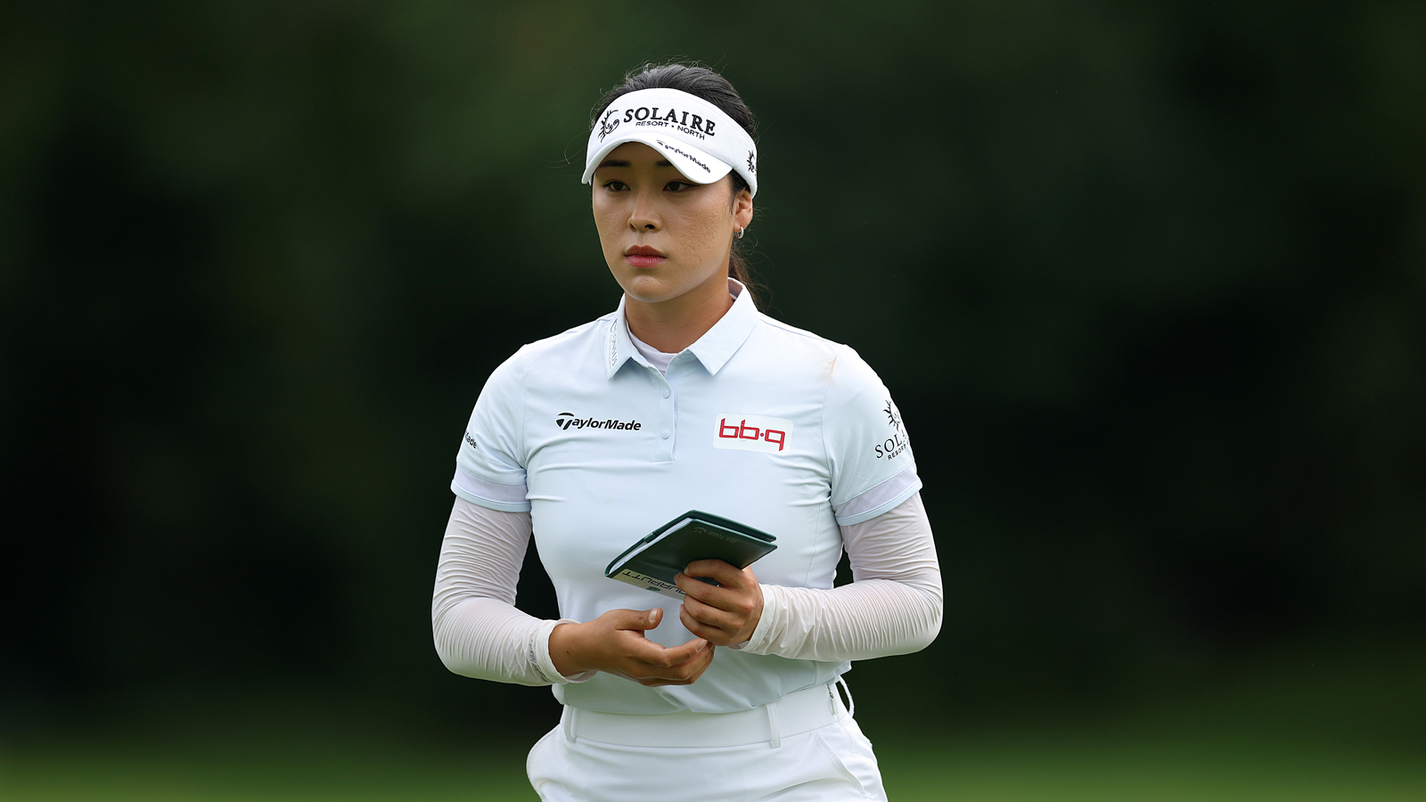 Ina Yoon walks up to the green holding a yardage book