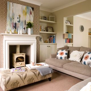 living room with cream colour wall cream colour sofa with cushion and wall shelf