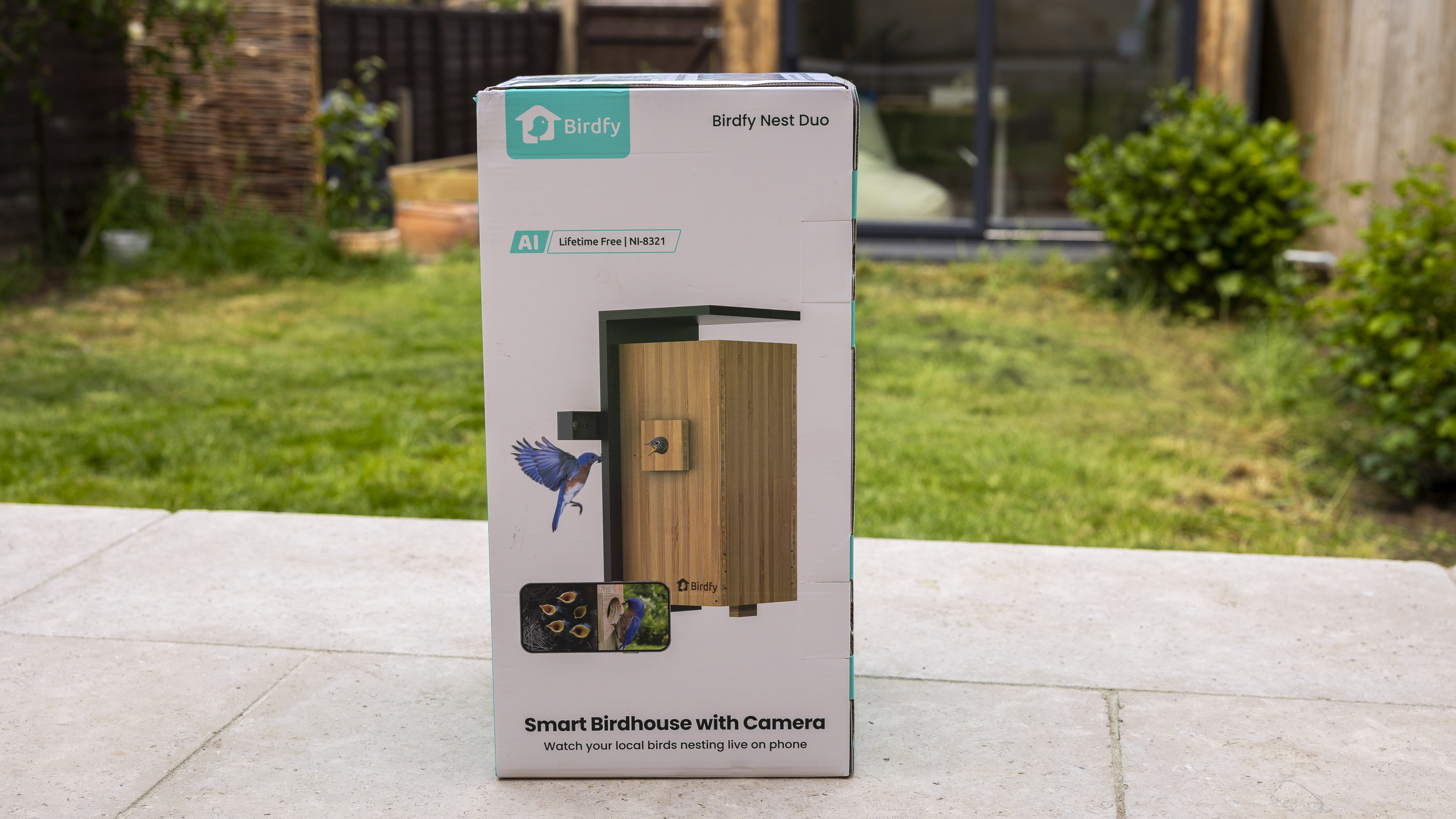The Birdfy Nest Duo box on a patio in a sunny garden