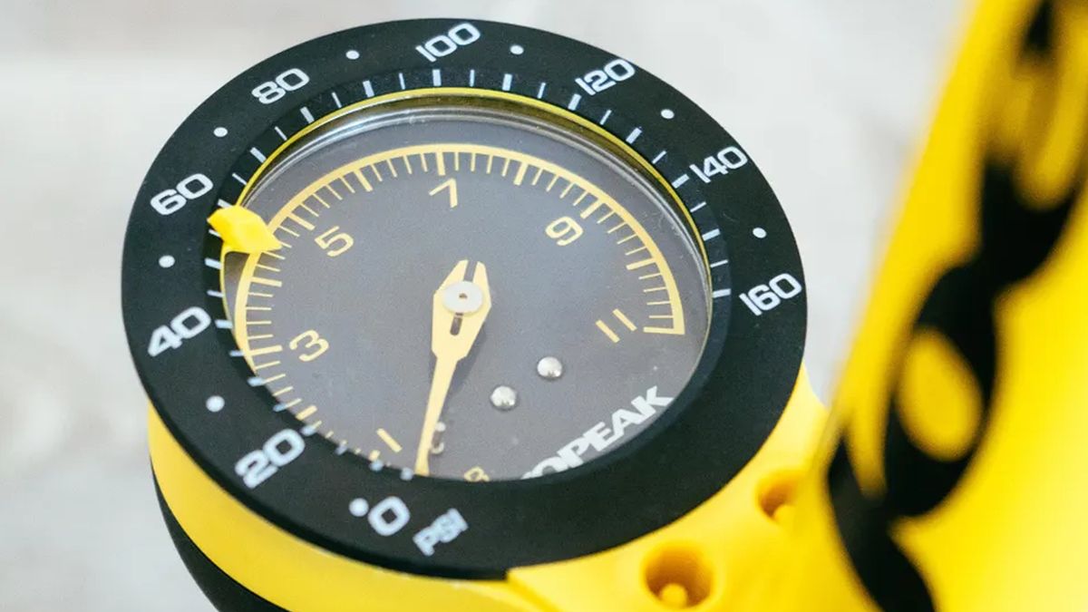 a close up of the yellow dial of a floor pump