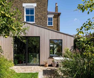 timber clad modern extension with pitched roof and large glazed doors