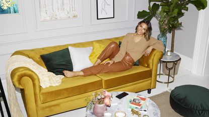 Frankie Bridge lying on couch for home essentials