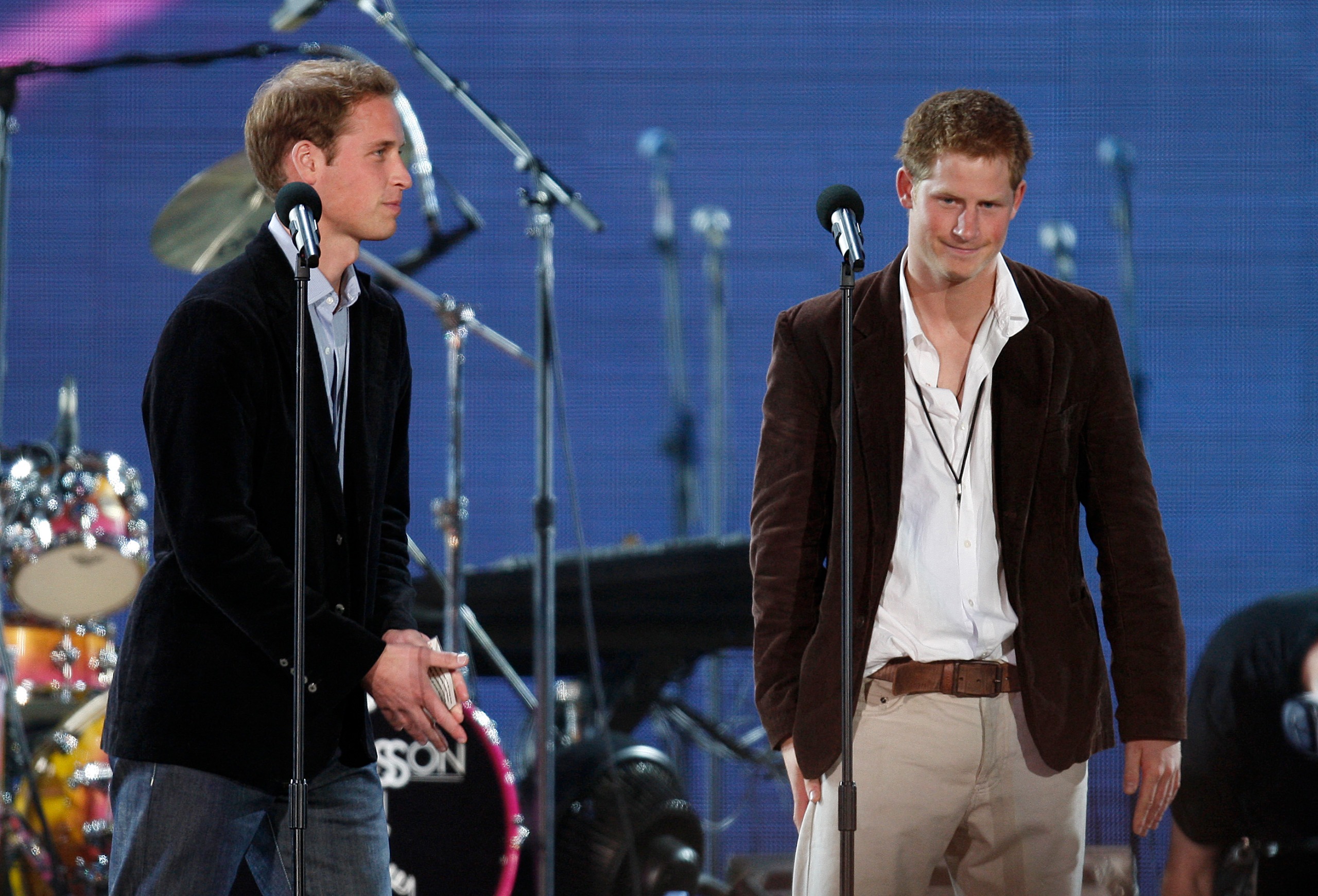 Prince Harry and Prince William speaking into microphones