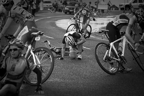 One of the riders involved in the pile-up tries to get to her feet after a multiple rider crash just after the finish to the womens criterium.