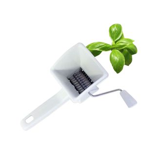 Cuisinox Rotary Herb Chopper in white with basil at the top