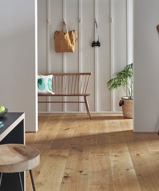 A panelled hallway leading into an open plan kitchen