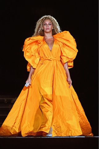 Beyoncé wears a yellow gown as she performs onstage during the "On The Run II" Tour - New Jersey at MetLife Stadium on August 2, 2018 in East Rutherford, New Jersey.