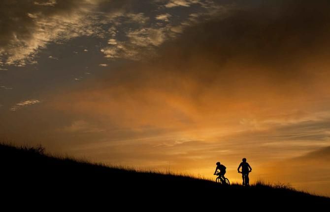 Riders during the prologue near sunset