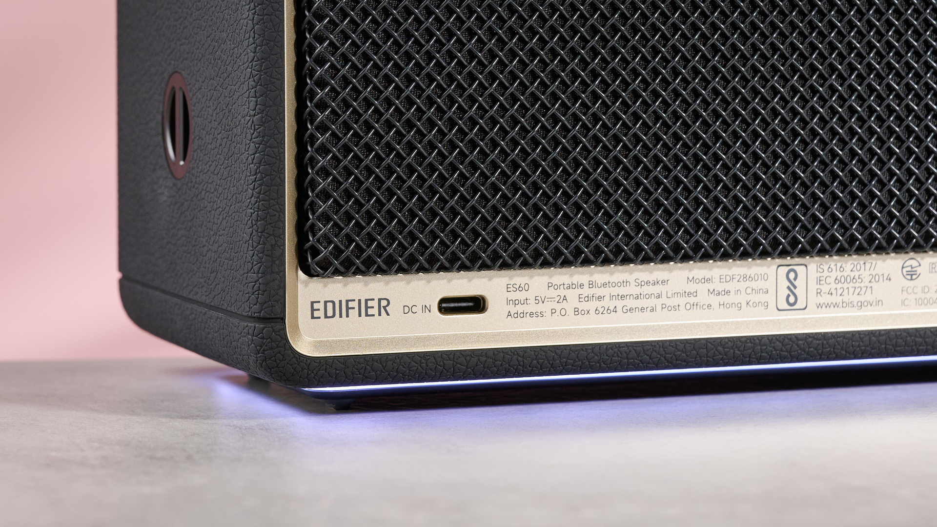 Edifier ES60 on table, against pink background with lights active