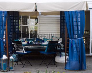 gazebo with blue curtains and seating