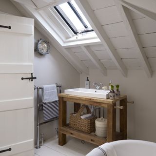 wood vanity unit in white loft converted bathroom wood beam ceiling painted white
