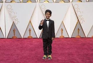 Lion star Sunny Pawar posing on Oscars red carpet
