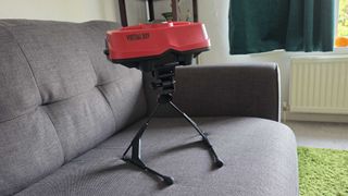 The Virtual Boy on a gray sofa