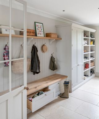 white and wooden boot room with panelled walls