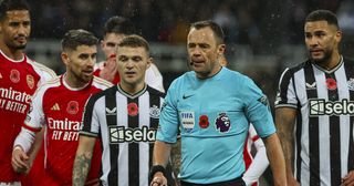 Players surround referee Stuart Attwell as VAR checks the Newcastle United goal during the Premier League match between Newcastle United and Arsenal FC at St. James Park on November 4, 2023 in Newcastle upon Tyne, England.