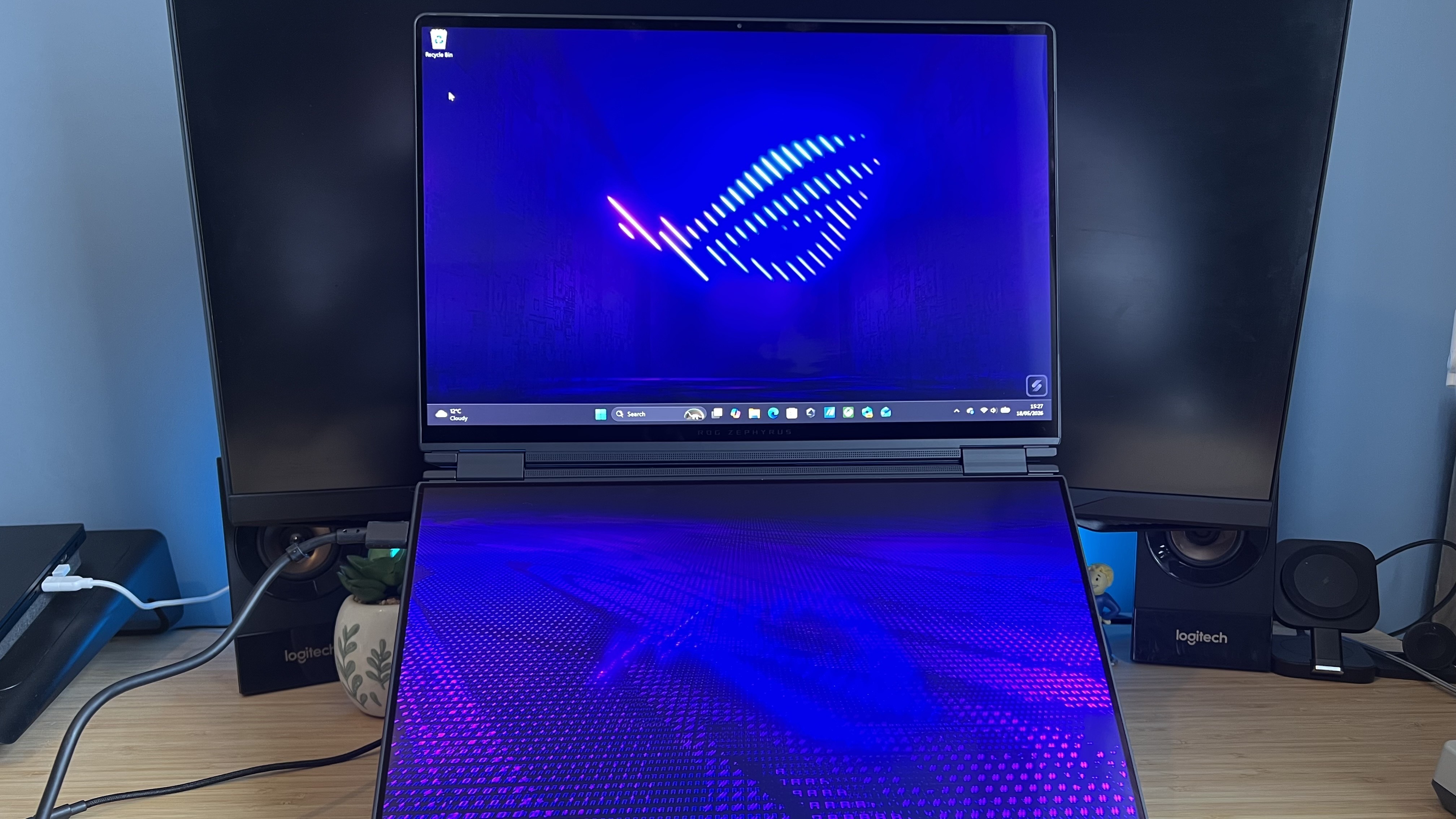 Asus ROG Zephyrus Duo in dual-screen mode on a wooden desk