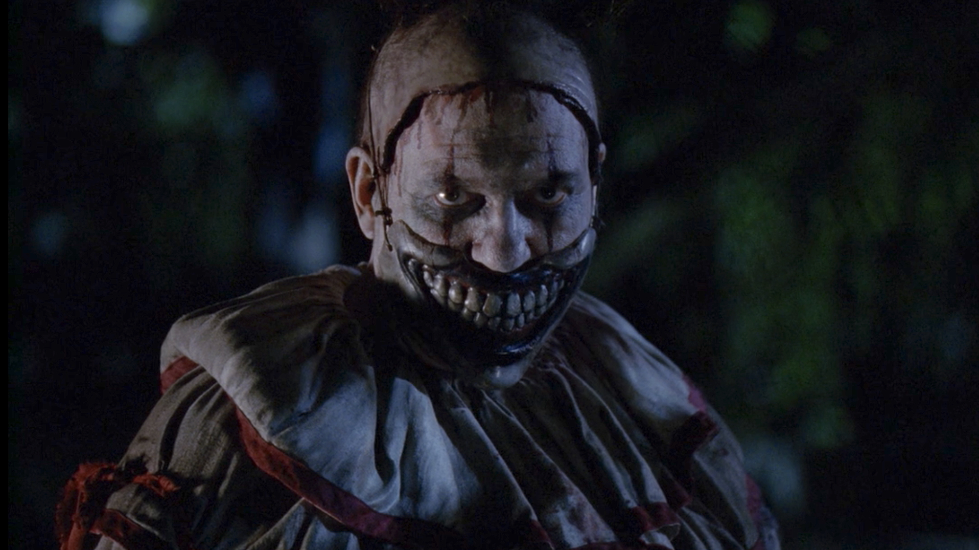 Twisty the Clown looking menacingly while standing outside in American Horror Story Season 4