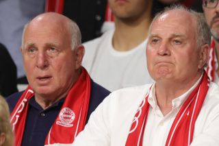 Uli Hoeness and brother Dieter watch Bayern Munich in a basketball game against Alba Berlin in 2019.