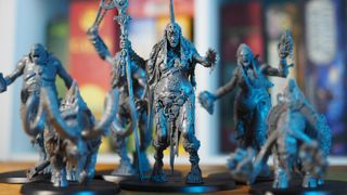 The models from the new Sons of Behemat range, against a shelf unit of board games