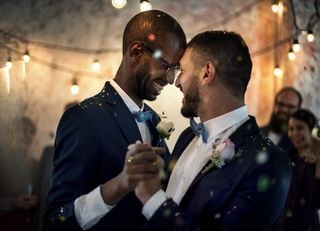 two grooms dance at their wedding