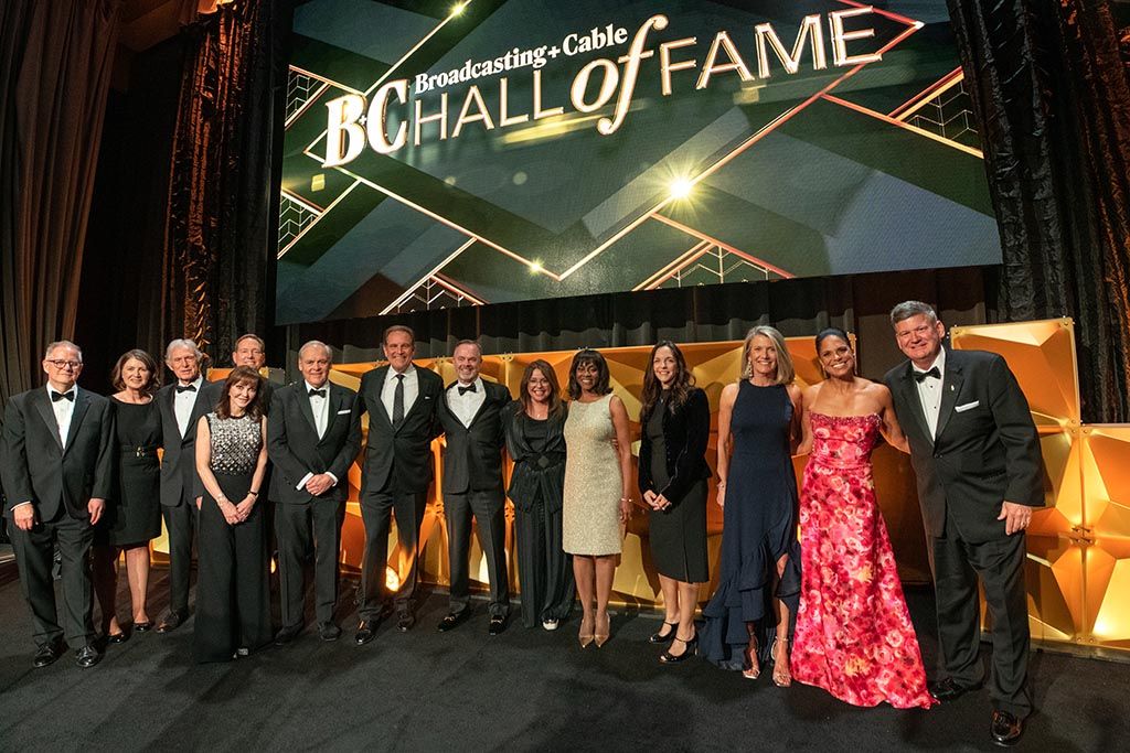 On stage at the Ziegfeld Ballroom for the B+C Hall of Fame (l. to r.): Kent Gibbons, content director, B+C, Multichannel News and NextTV; Carmel King, MD, B2B Tech &amp; Entertainment, Future; Bill McGorry, chair, B+C Hall of Fame; honorees Caroline Beasley, Matt Bond, Frank Comerford, Jim Nantz, Ray Hopkins, Rachael Ray and Wonya Lucas; Kristin Dolan, CEO, AMC Networks; Cathy Thompson, wife of the late Jim Thompson; and honorees Soledad O’Brien and Ray Cole.