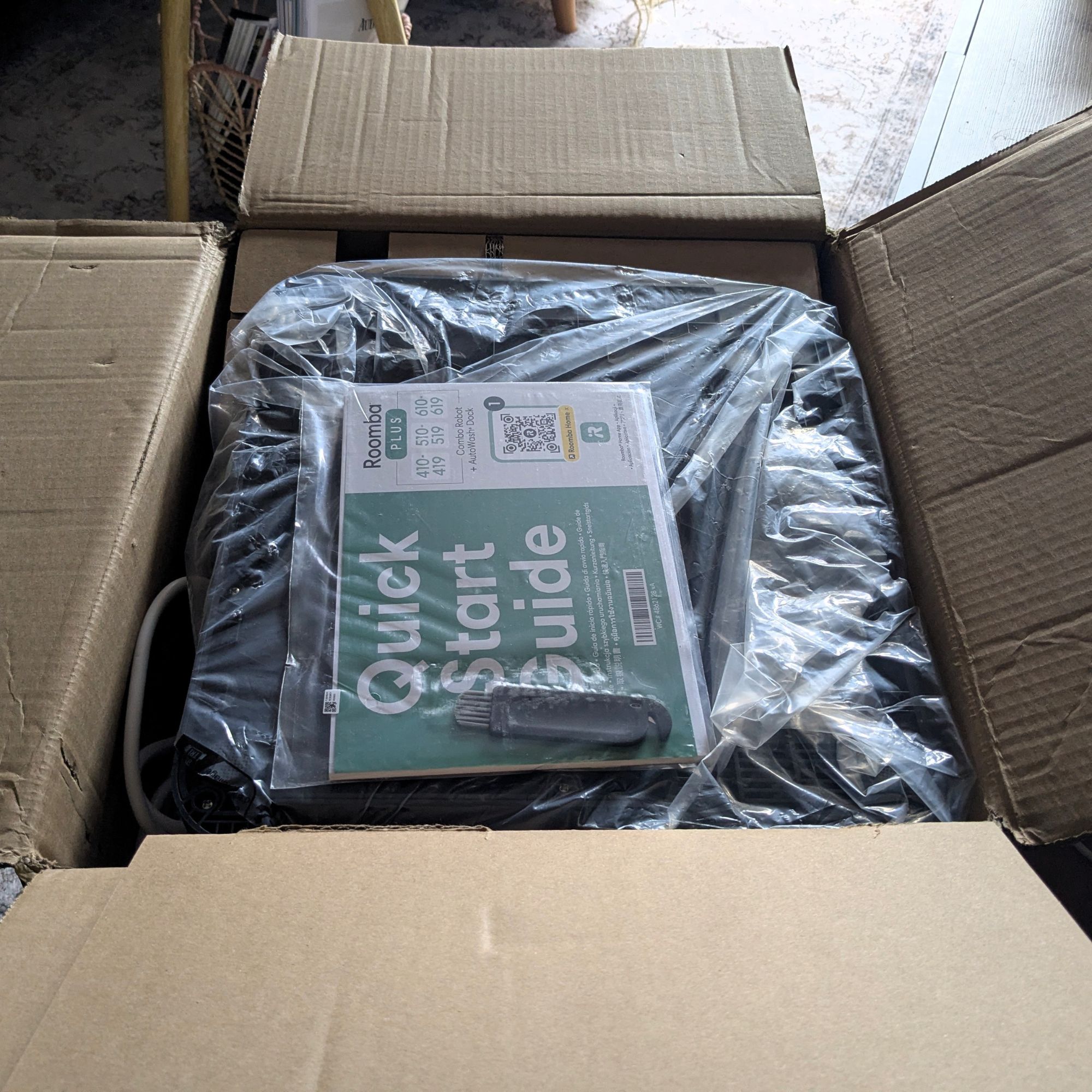 iRobot Roomba Plus 415 Combo robot vacuum wrapped in packaging in a cardboard box
