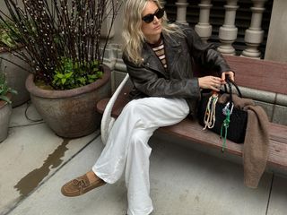 Lucy Williams wearing a leather biker jacket, trousers, and boat shoes.